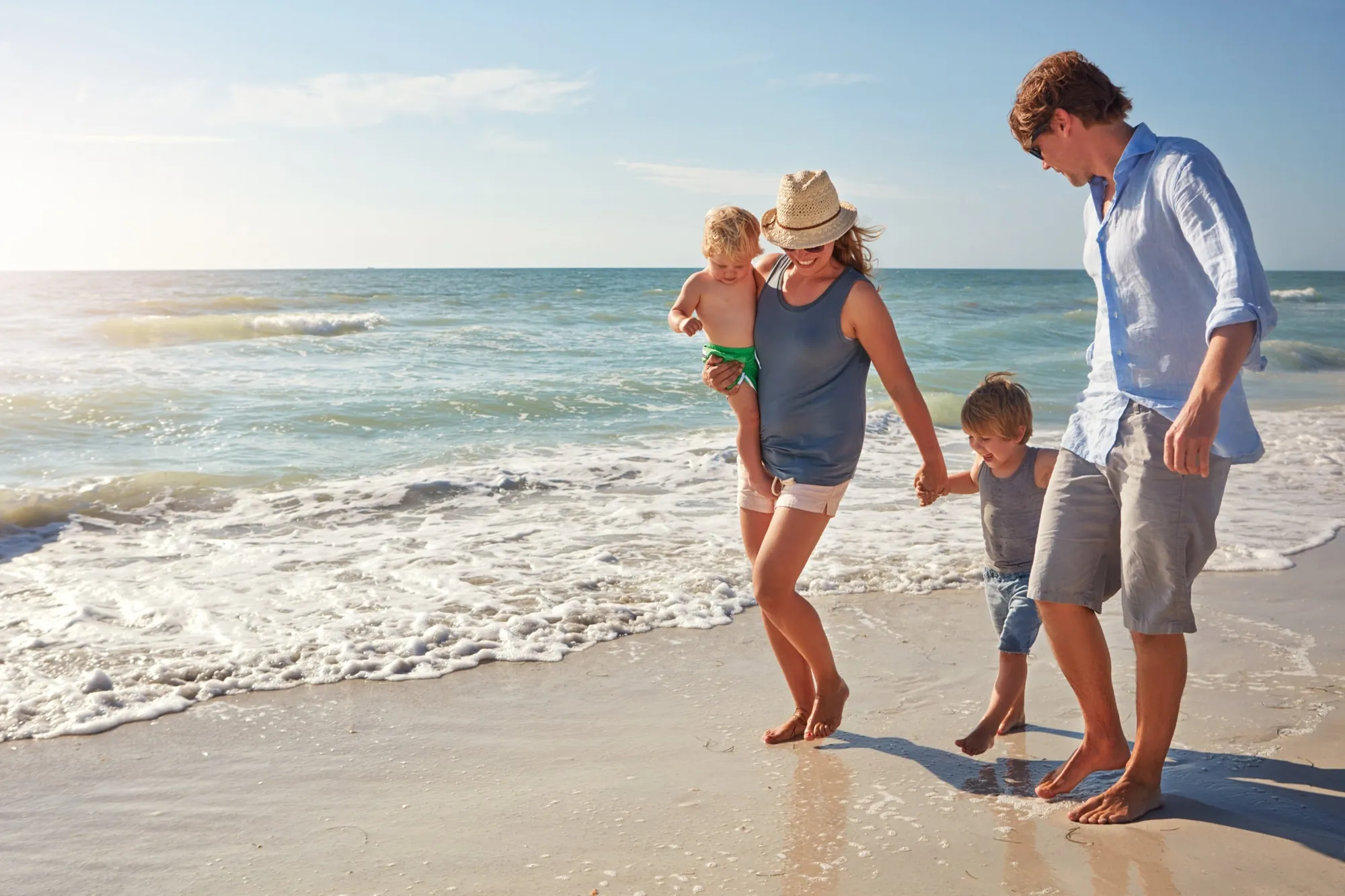 Familie barfuß am Strand